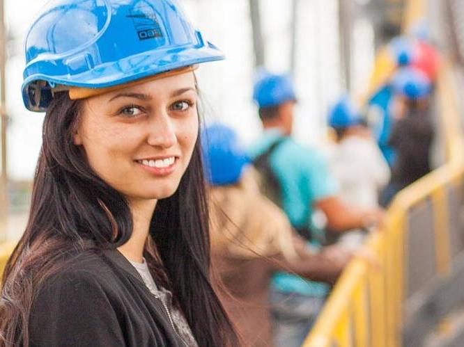 young women wearing contruction hat